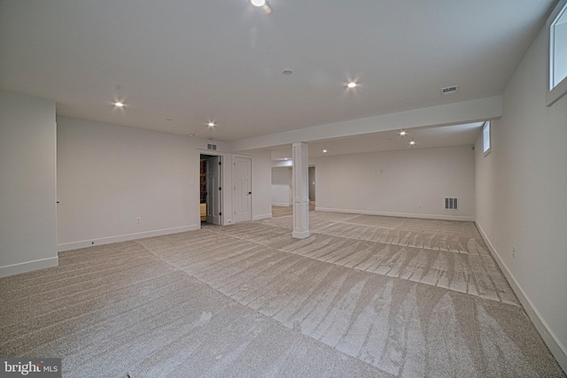 finished below grade area featuring light carpet, baseboards, visible vents, and recessed lighting