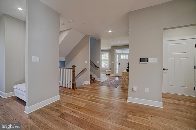 entryway with light wood-type flooring and baseboards