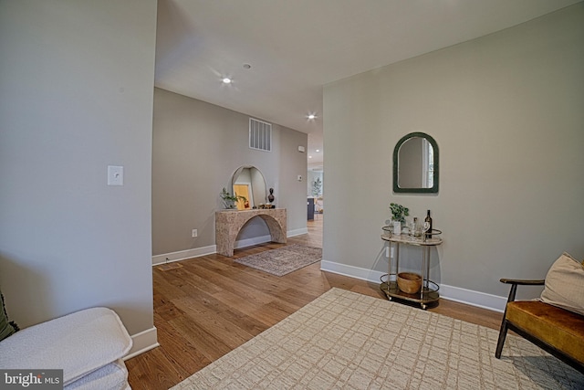 corridor with visible vents, baseboards, wood finished floors, and recessed lighting