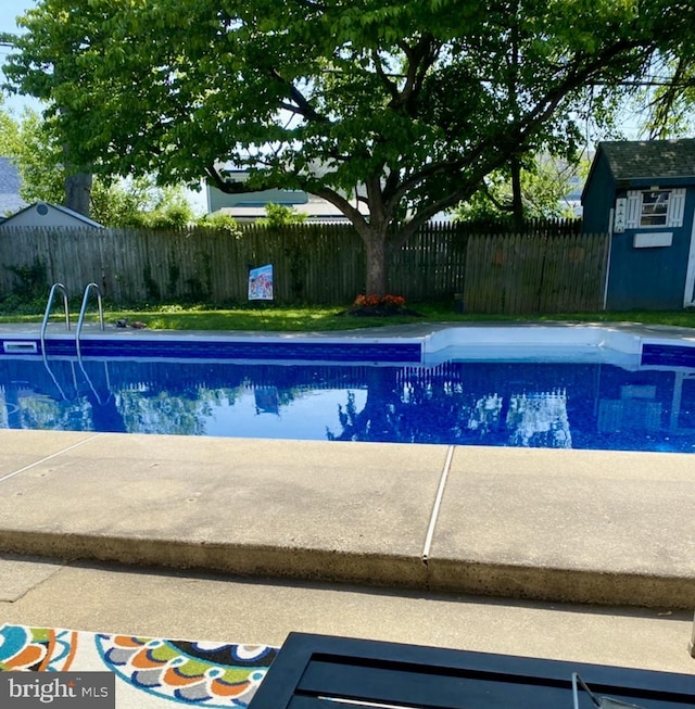 view of swimming pool with a fenced in pool and fence