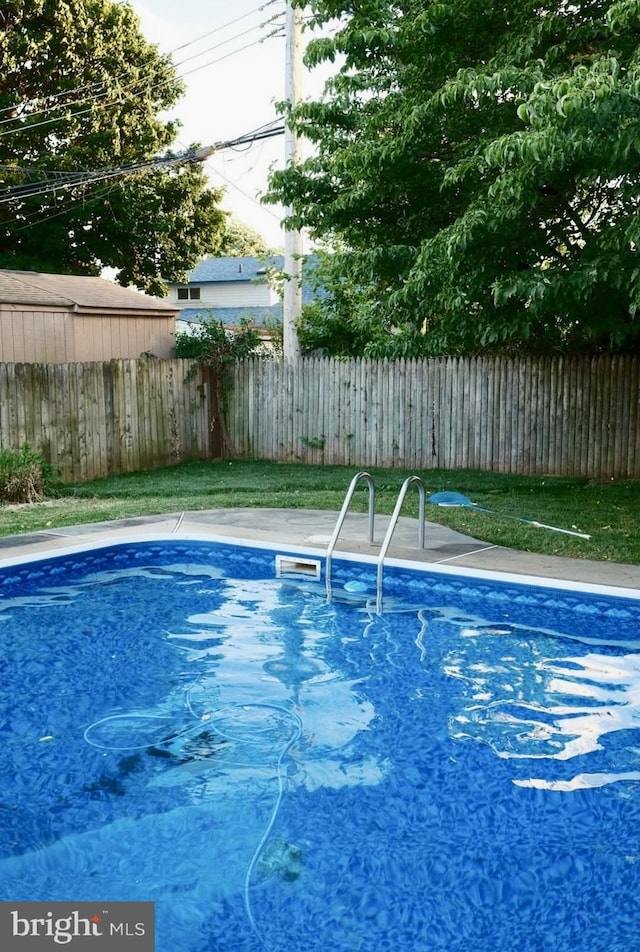 view of pool featuring fence