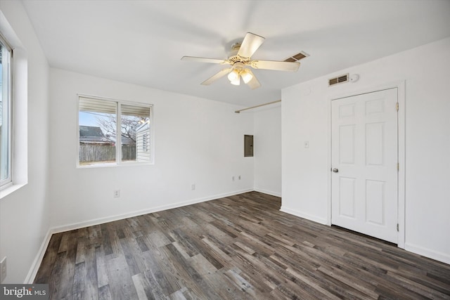 unfurnished bedroom featuring dark wood-type flooring, visible vents, baseboards, and a ceiling fan