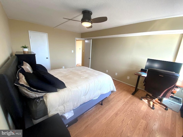 bedroom featuring a ceiling fan and light wood-type flooring