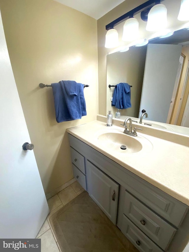 bathroom featuring tile patterned flooring and vanity