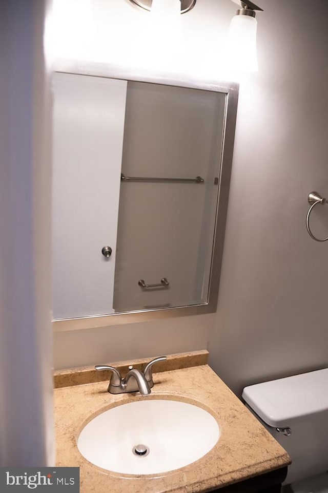 bathroom featuring toilet and vanity