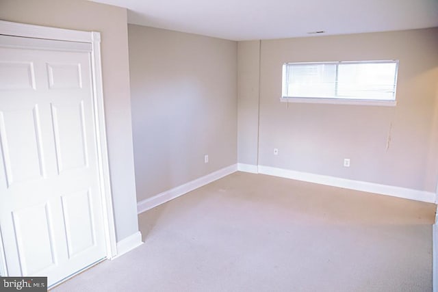 unfurnished room with baseboards and carpet floors