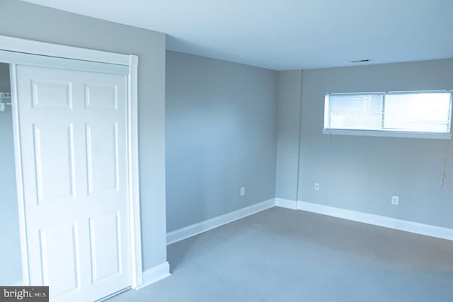 unfurnished bedroom featuring visible vents, concrete flooring, and baseboards