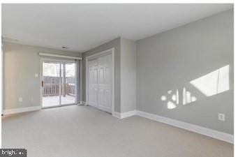 spare room with baseboards