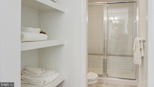 full bathroom with toilet and a shower stall