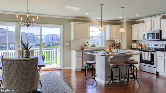 kitchen featuring tasteful backsplash, white cabinets, dark wood-style floors, ornamental molding, and stainless steel appliances