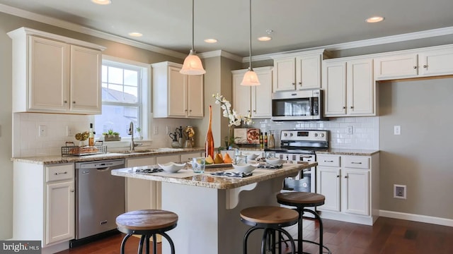 kitchen with stainless steel appliances, white cabinetry, crown molding, and dark wood-type flooring