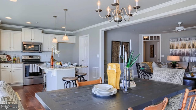 dining room with recessed lighting, ceiling fan with notable chandelier, visible vents, dark wood finished floors, and crown molding