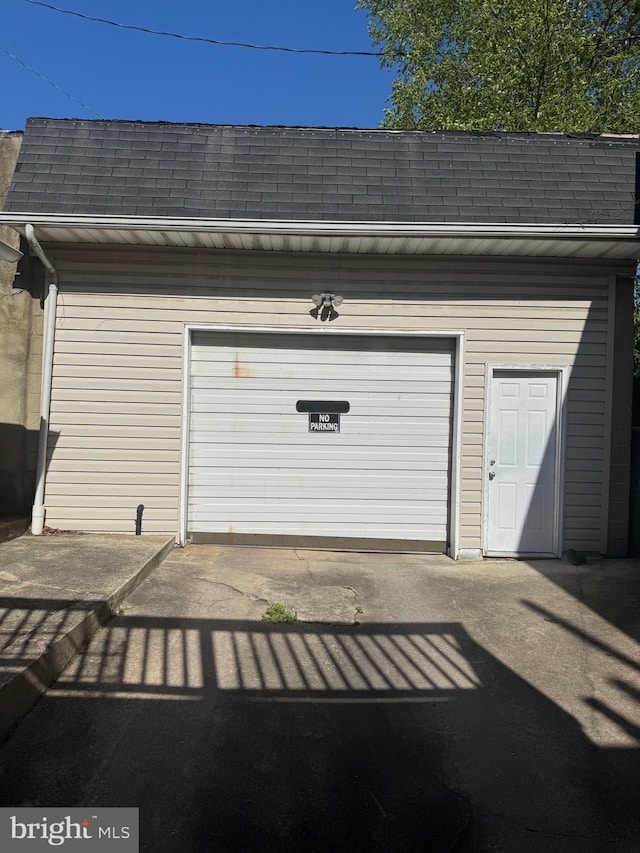 garage featuring concrete driveway