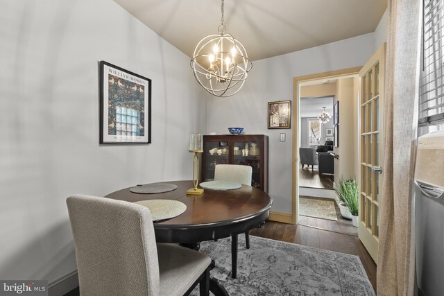 dining room with an inviting chandelier and hardwood / wood-style flooring