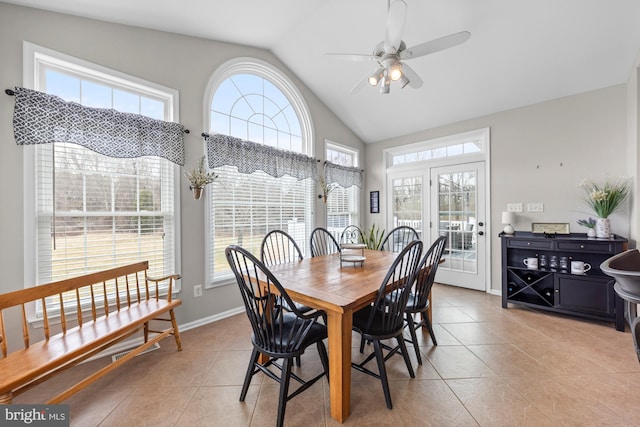 dining room with high vaulted ceiling, ceiling fan, baseboards, and light tile patterned floors