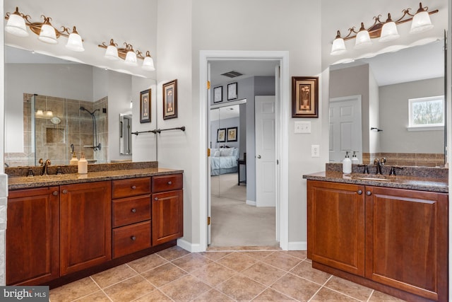 full bath featuring tile patterned flooring, vanity, visible vents, a tile shower, and ensuite bath