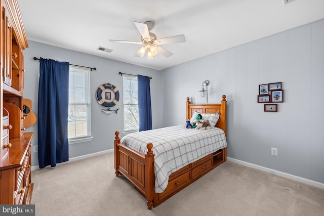 bedroom featuring ceiling fan, visible vents, baseboards, and light colored carpet