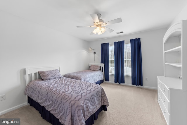 bedroom featuring light colored carpet, visible vents, ceiling fan, and baseboards