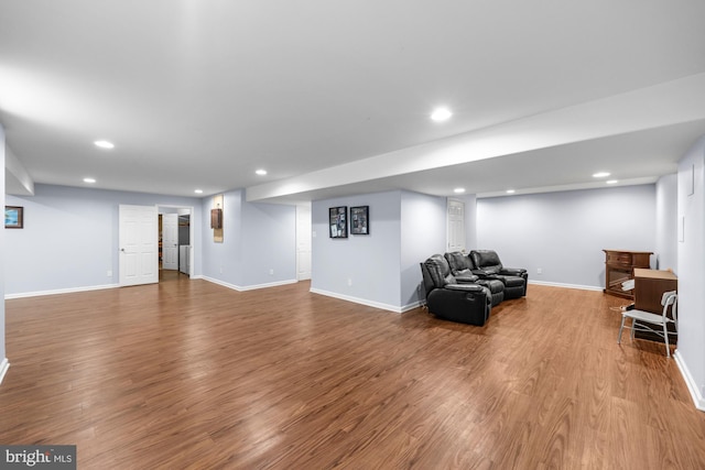 living room with recessed lighting, baseboards, and wood finished floors