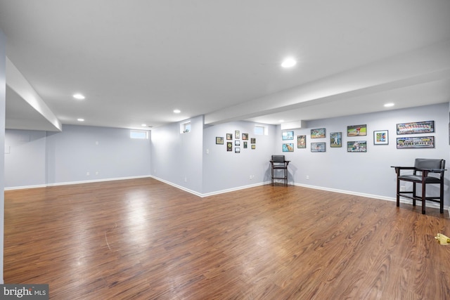 basement with baseboards, wood finished floors, and recessed lighting