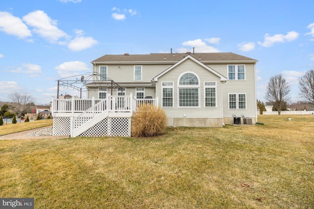 back of house with a deck, a gazebo, central AC unit, and a lawn