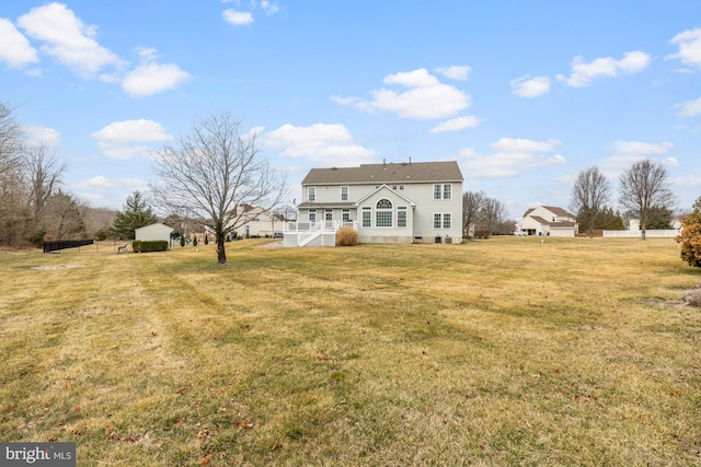 back of house with a lawn