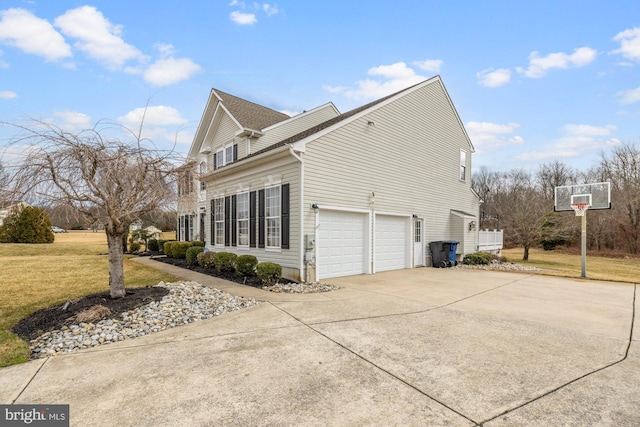 view of side of property with a garage, a lawn, and concrete driveway