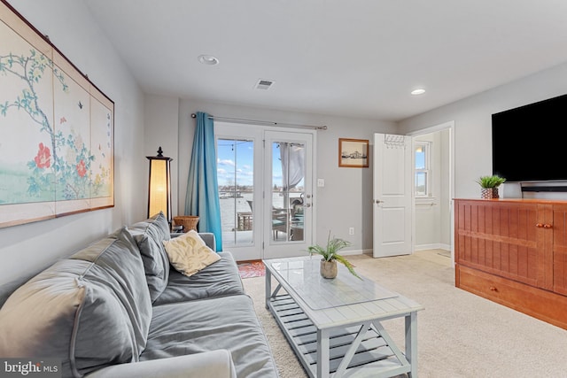 carpeted living room featuring recessed lighting, visible vents, and baseboards