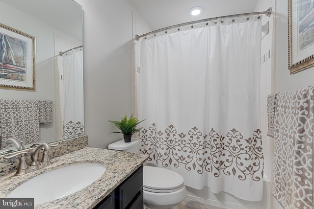 bathroom with toilet, shower / tub combo with curtain, and vanity