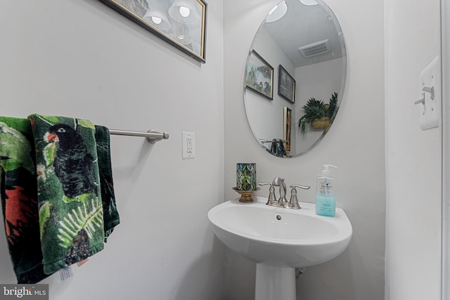 bathroom featuring visible vents and a sink