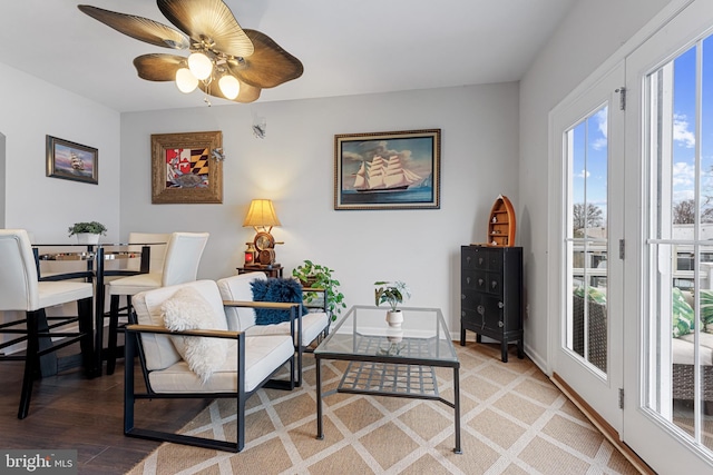 sitting room with light wood-style floors, ceiling fan, and baseboards