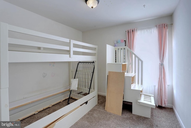 bedroom with baseboards and carpet floors