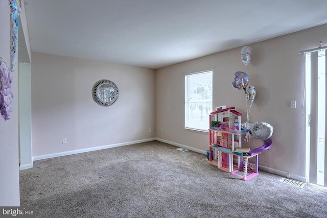 rec room with visible vents, baseboards, and carpet floors