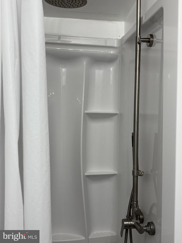 interior space featuring a shower with shower curtain