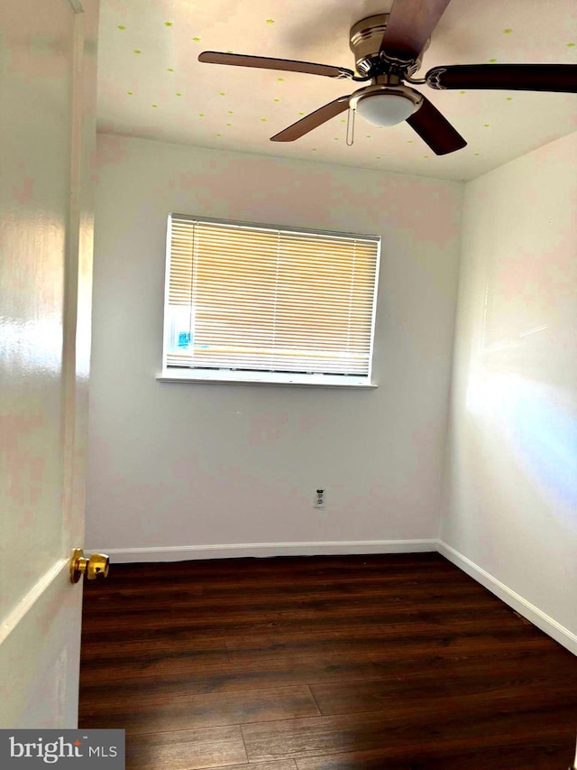 empty room with ceiling fan, baseboards, and wood finished floors