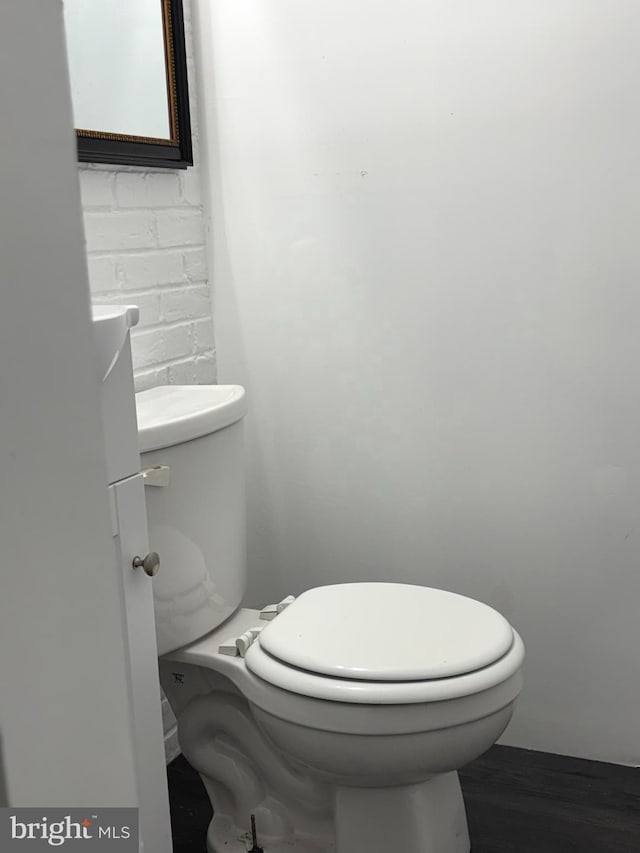 bathroom with toilet and wood finished floors