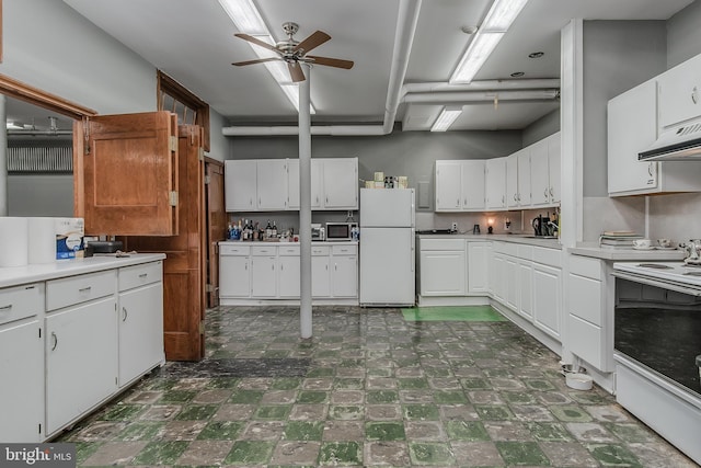 kitchen with white appliances, ceiling fan, dark floors, light countertops, and under cabinet range hood