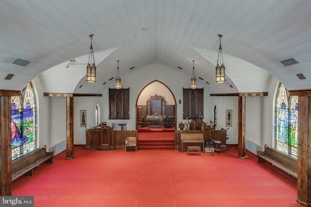 misc room with vaulted ceiling, carpet flooring, visible vents, and baseboards