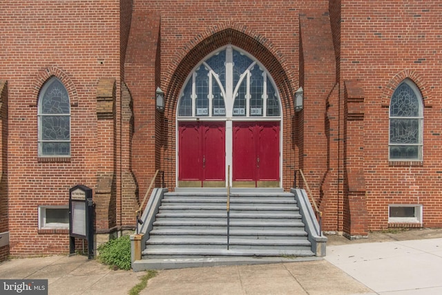 property entrance featuring brick siding