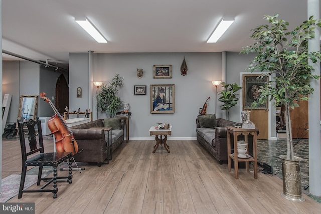 living room featuring wood finished floors and baseboards