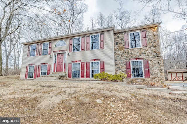 split foyer home with stone siding