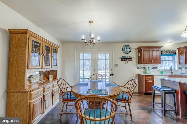 dining space with a chandelier and dark wood finished floors