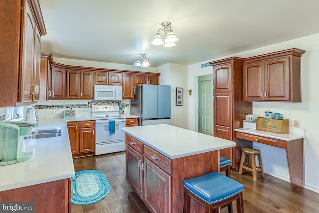 kitchen featuring white appliances, dark wood-style flooring, a sink, light countertops, and backsplash