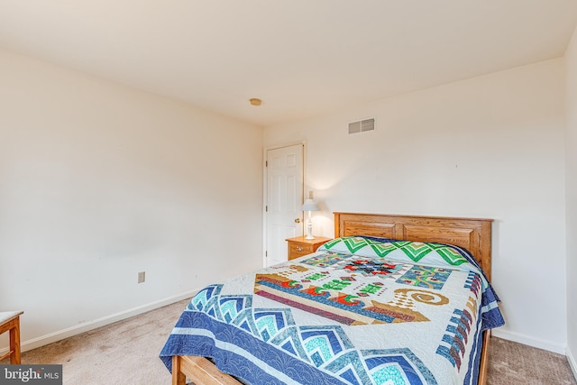 bedroom featuring visible vents, light carpet, and baseboards