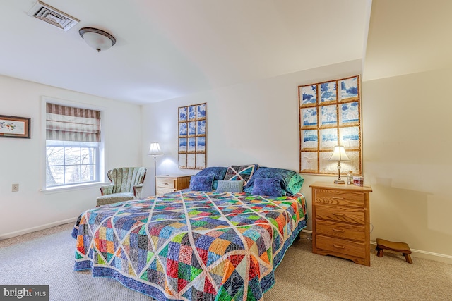 carpeted bedroom featuring baseboards and visible vents