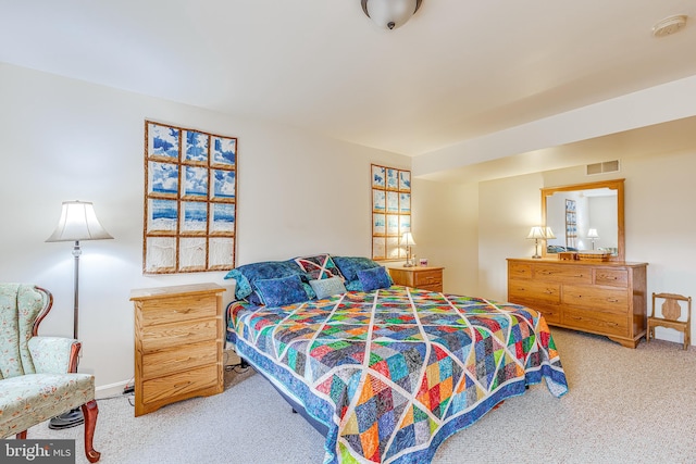 bedroom featuring carpet floors, visible vents, and baseboards