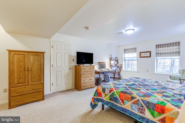 bedroom featuring baseboards, visible vents, and light colored carpet