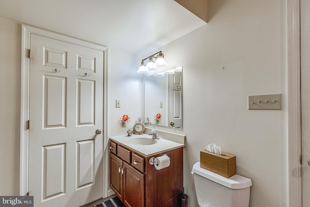 bathroom featuring toilet and vanity