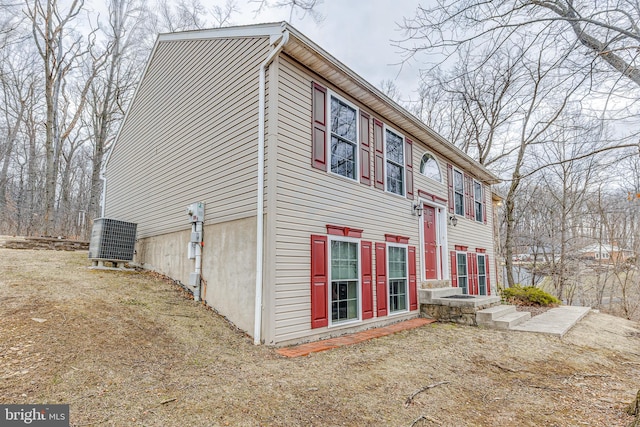 back of house featuring central air condition unit