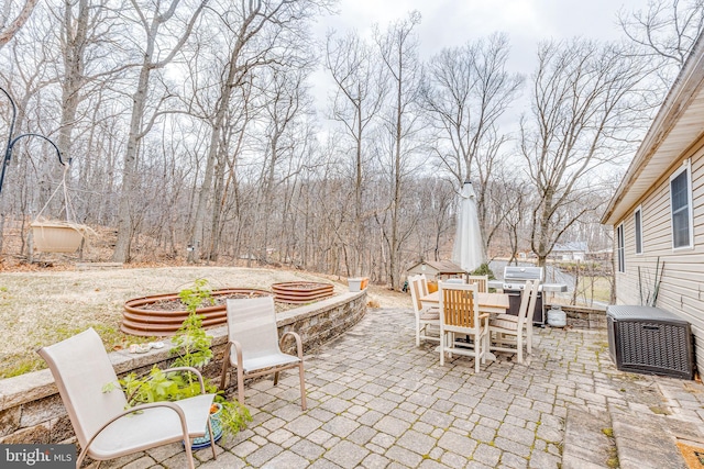 view of patio with outdoor dining area, grilling area, and central AC unit